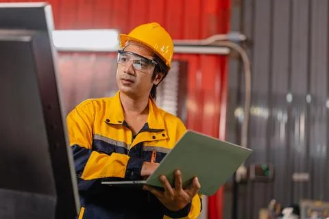 Asian Engineer male worker work control operate machine control panel in me.. Stock Photos