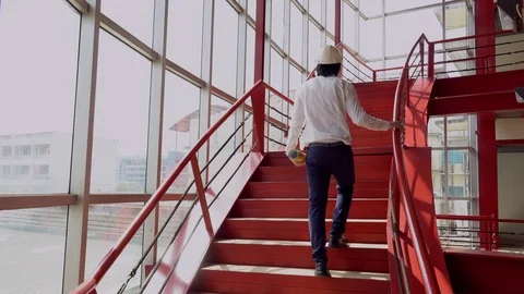 Asian engineer man walking up on red stair at construction site Stock-Footage 90626810