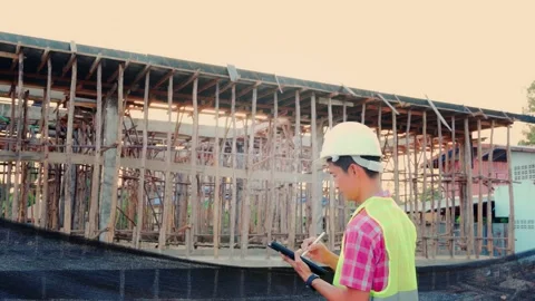 Asian engineer or architect is inspecting a site construction with a tablet devi Stock Footage 163089092