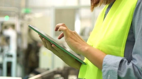 Asian engineer wearing a white safety helmet while working with a Tablet . Video stock 121844566