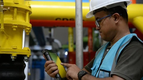 Asian engineer wearing working in the boiler room Stock Footage 94963765