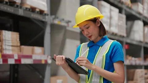 Asian engineer woman checking goods and supplies on shelves in ware house. Video stock 218876002