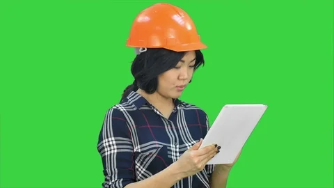 Asian engineer woman using tablet on a Green Screen, Chroma Key Stock Footage