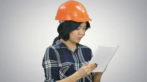 Asian engineer woman using tablet on white background Stock Footage 90353796
