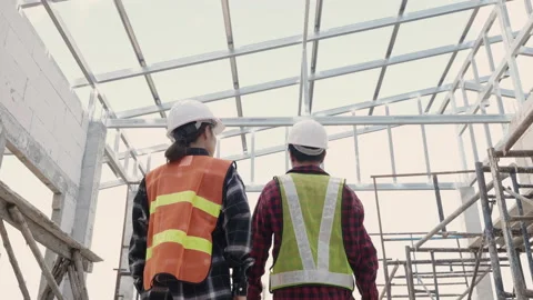 Asian engineer worker in protective helmet walking to checking at the house Stock Footage 171501266