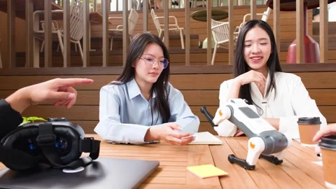 Asian Engineering Students Collaborating on Robot Dog Project in University Stock Footage 346815457