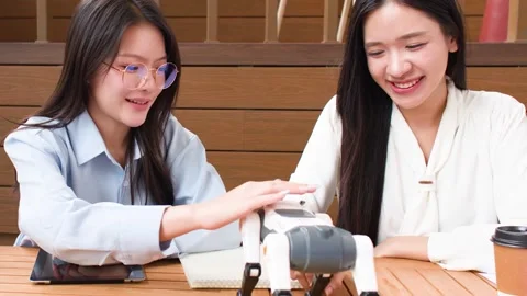 Asian Engineering Students Collaborating on Robotic Dog Project in University Stock Footage 345783961