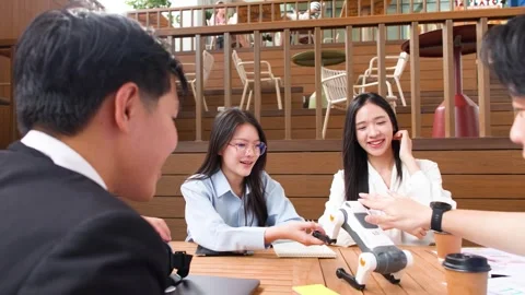Asian Engineering Students Collaborating on Robotic Dog Project Outdoors Stock Footage 345784552