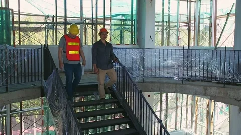 Asian engineering team go down the stairs in construction site. Stock Footage 191969352