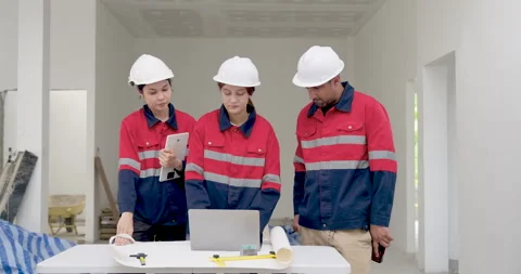 Asian engineering team reviews digital construction workflow on laptop, Stock Footage 342227087