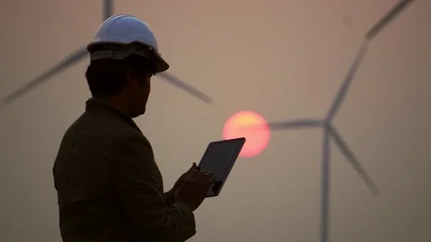 Asian engineers are checking the wind turbine system with a tablet Stock Footage