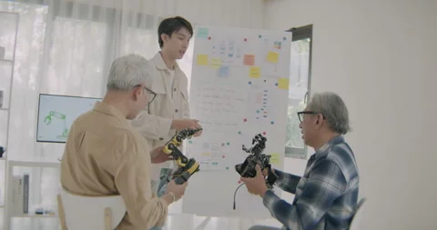 Asian Engineers Collaborating On Robotic Arm Development During Coding Class. Stock Footage 308160994