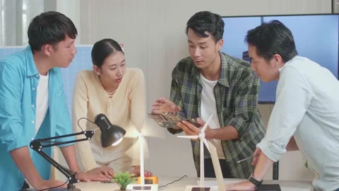 Asian Engineers Group Discussing About Green Circuit Board While Testing Stockbeeldmateriaal 201338661