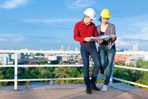 Asian engineers reading draft together Stock Photos