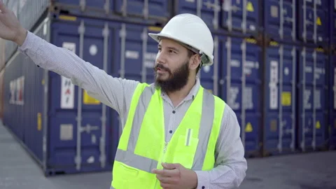 Asian Engineers Standing talking about a container yard located behind him. He's Stock Footage 168954755