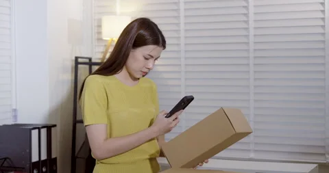 Asian entrepreneur using smartphone to record parcel information, checking Video stock 330840340
