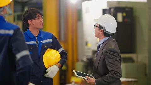 Asian Factory Manager with Tablet Talking to Industrial Worker Stock Footage 343428784