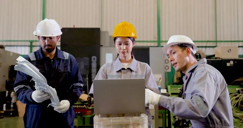 Asian factory staff study molded part near laptop, comparing machine condition, Stock Footage 338072653