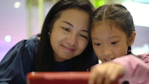 Asian family enjoy using computer tablet together, handheld dolly 4K Video stock 103066720