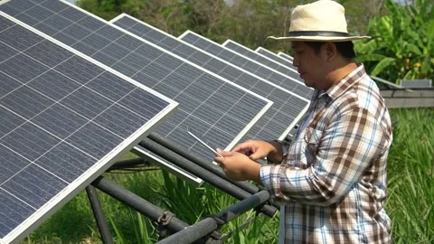 Asian farmers use tablets to adjust solar cells degree and check solar cell p Stock Footage 148518556