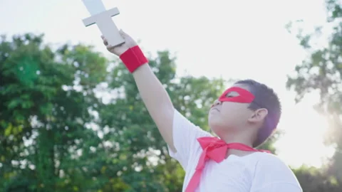 Asian fat boy point sword up to the sky in the park, going out to the park Stock Footage 173353370