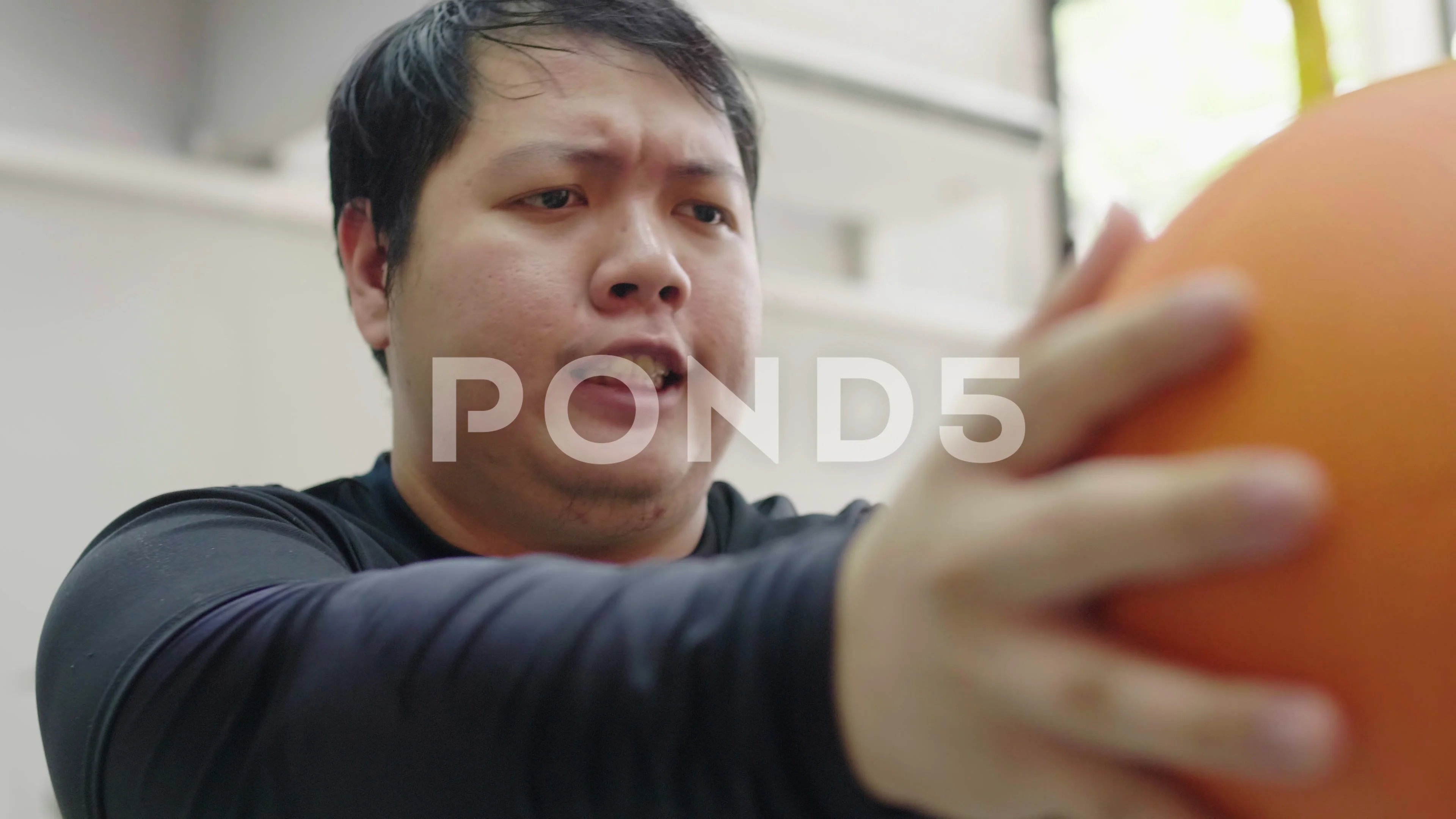 Asian fat man trying to exercise with medicine ball in fitness gym, Healthy  life