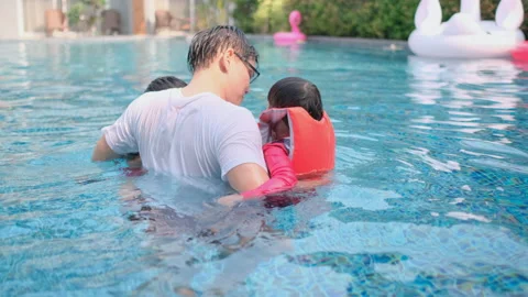 Asian father bring both daughter and son enjoy in hotel swimming pool Stock Footage 153800340
