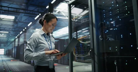 Asian Female Data Center Engineer Using Laptop Computer Stock Footage 319995428
