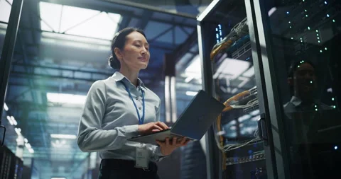 Asian Female Data Center Engineer Using Laptop Computer Stock Footage 319995471