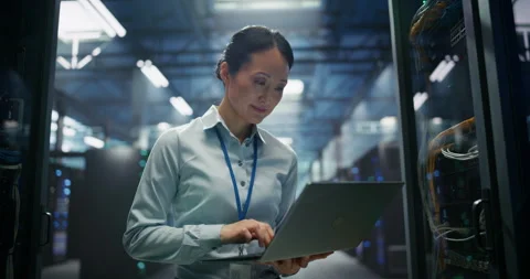 Asian Female Data Center Engineer Using Laptop Computer Stock Footage 319995502