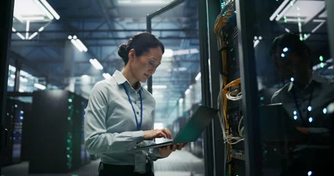Asian Female Data Center Engineer Using Laptop Computer Stock Footage 319995535