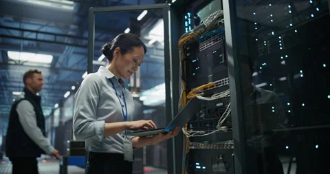 Asian Female Data Center Engineer Using Laptop Computer Stock Footage 319995751