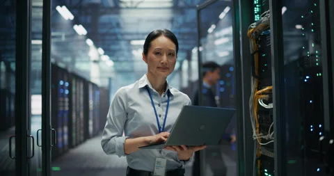 Asian Female Data Center Engineer Using Laptop Computer Stock Footage 319997874