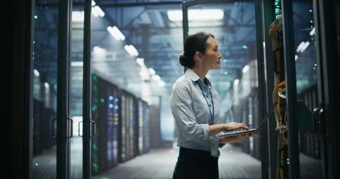 Asian Female Data Center Engineer Using Laptop Computer Stock Footage 319998134