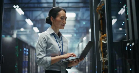 Asian Female Data Center Engineer Using Laptop Computer Stock Footage 319998268