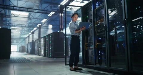 Asian Female Data Center Engineer Using Laptop Computer Stock Footage 320000093