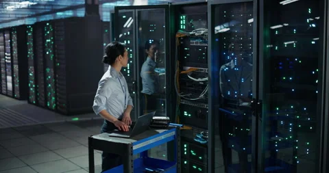 Asian Female Data Center Engineer Using Laptop Computer Stock Footage 320000424