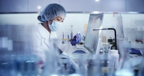 Asian female doctor working in laboratory. Studying medical samples Stock Footage