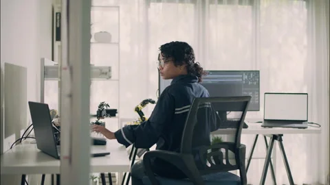 Asian Female Engineer Analyzing Code and Robotics Project in Modern Workspace Stock Footage 307587530