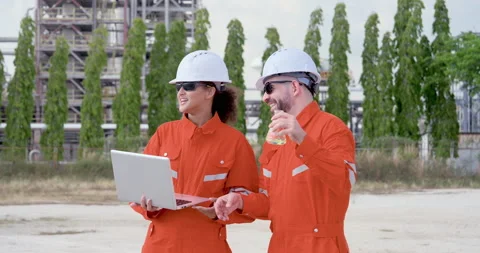 Asian female engineer and multiracial male technician discuss laptop data while Stock Footage 344393196