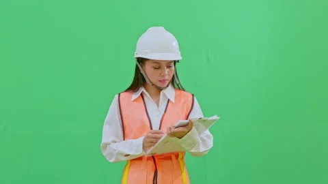 Asian Female Engineer Dusting Off Clipboard on Green Screen Background Stock Footage 331628014
