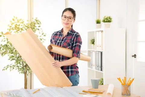 Asian female engineer put draft under armpit Stock Photos