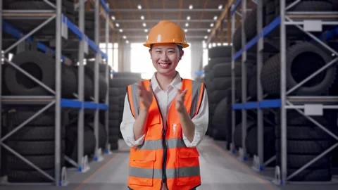 Asian Female Engineer Smiling And Clapping Her Hands at Tire Warehouse Stock Footage 341788381