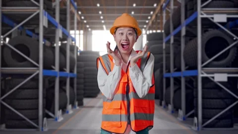 Asian Female Engineer Smiling To Camera And Saying Wow at Tire Warehouse Stock Footage 341787983