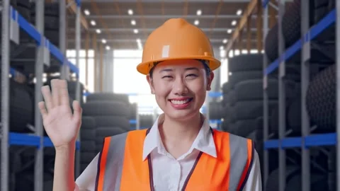 Asian Female Engineer Smiling To Camera Waving Hand Saying Bye Tire Warehouse Stock Footage 341788438