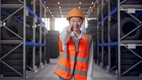 Asian Female Engineer Smiling Touching Her Chest Pointing At You Tire Warehouse Video stock 341787993