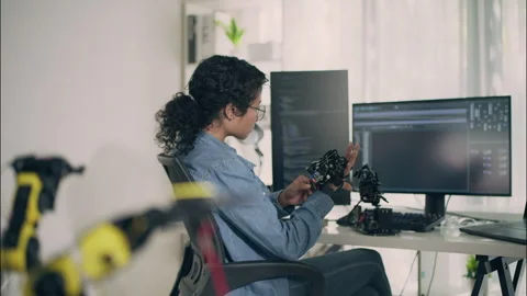 Asian Female Engineer Testing Robotic Hand in Modern Programming Lab. Stock Footage 307587357