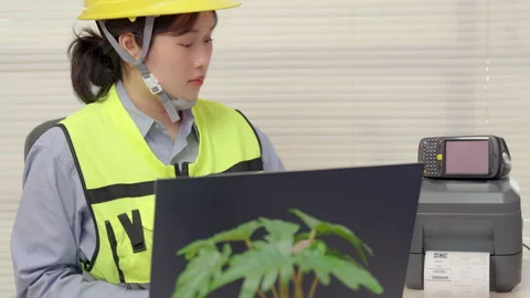 Asian female engineer uses a laptop or notebook to print barcode stickers Stock Footage 318966014