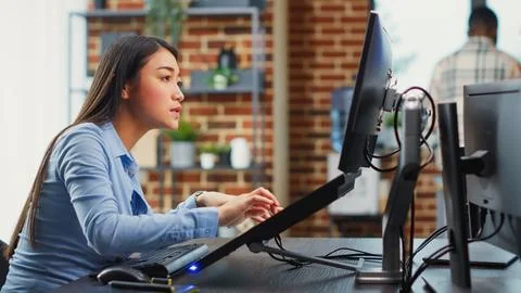 Asian female engineer using touchscreen display to create game interface Stock Photos