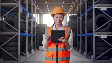 Asian Female Engineer Working On A Tablet at Tire Warehouse Video stock 341788160